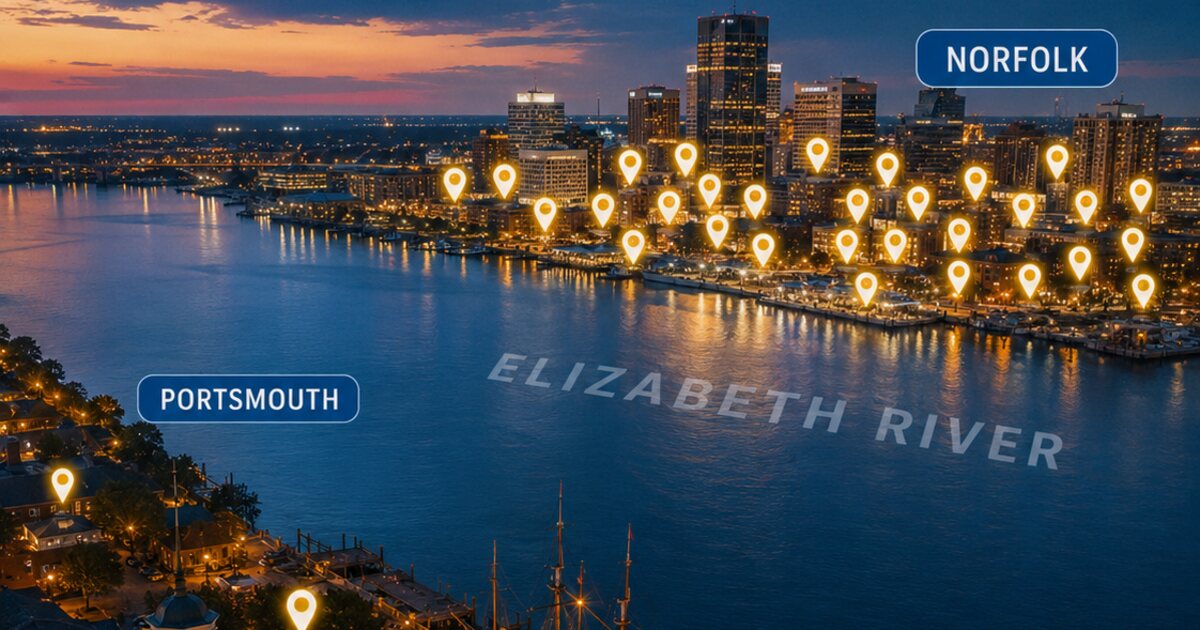 Aerial dusk view across the Elizabeth River showing Olde Towne Portsmouth in the foreground and the Norfolk skyline across the water crowded with glowing map pins